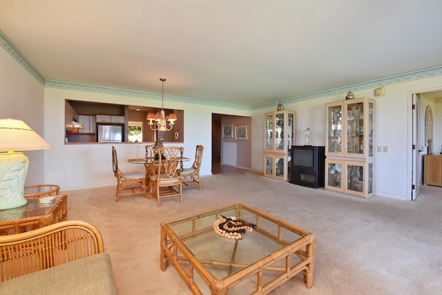 living room featuring light carpet, a notable chandelier, and ornamental molding