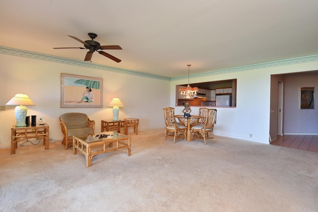 interior space with ceiling fan with notable chandelier and carpet floors