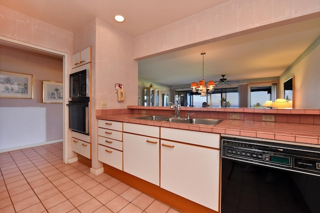 kitchen with white cabinetry, tile countertops, black appliances, decorative light fixtures, and sink