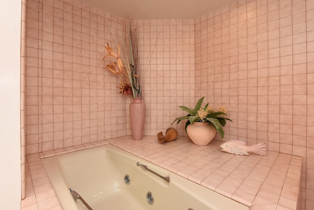 bathroom with tile patterned flooring and a bathing tub