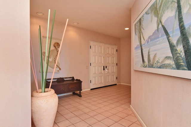 hall with light tile patterned floors