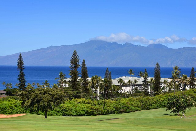 view of community with a water and mountain view and a yard