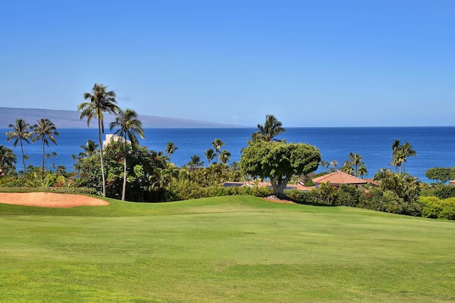 view of home's community with a lawn and a water view