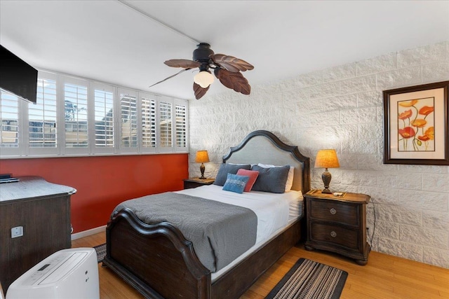 bedroom featuring ceiling fan and light wood-type flooring