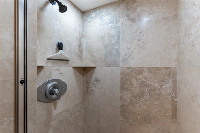 interior details featuring a tile shower