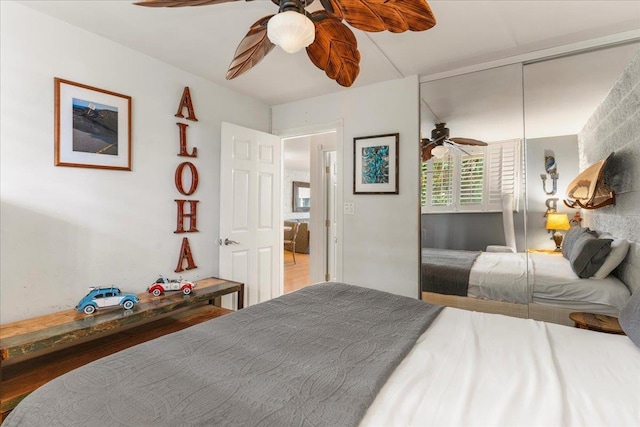 bedroom with ceiling fan and a closet