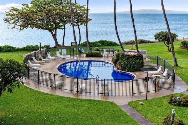 view of pool featuring a water view and a yard