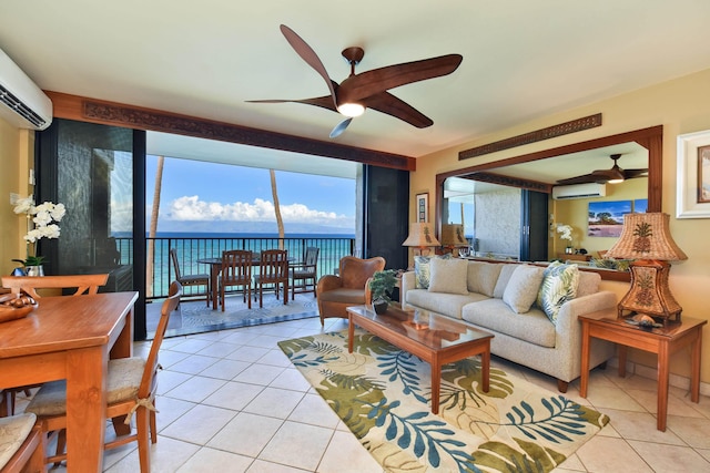 living room featuring ceiling fan, light tile patterned flooring, a water view, and an AC wall unit