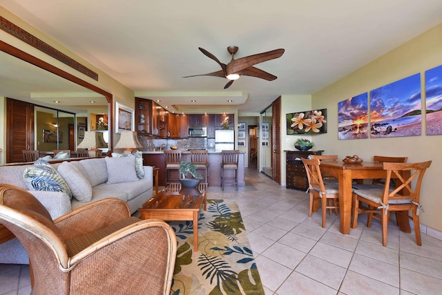 tiled living room featuring ceiling fan