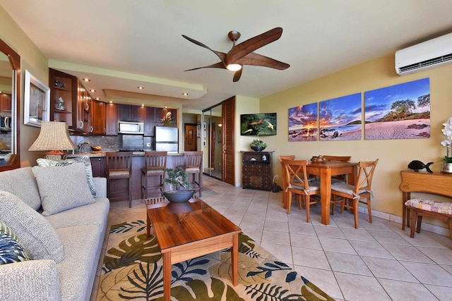 tiled living room featuring a wall mounted AC, ceiling fan, and sink