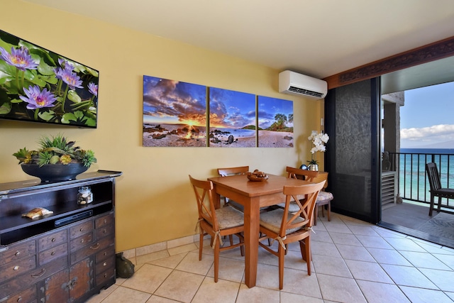 dining area featuring light tile patterned floors, a water view, and a wall mounted AC