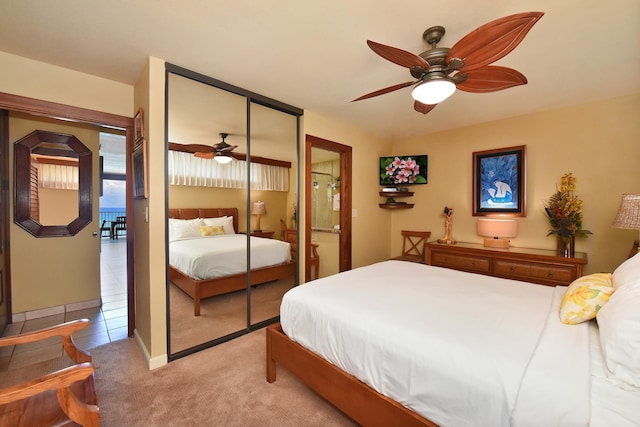 bedroom featuring light carpet, a closet, and ceiling fan