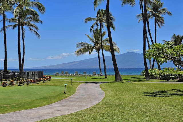 view of community featuring a yard and a water and mountain view