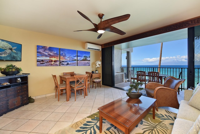 tiled living room featuring ceiling fan, a water view, and a wall unit AC