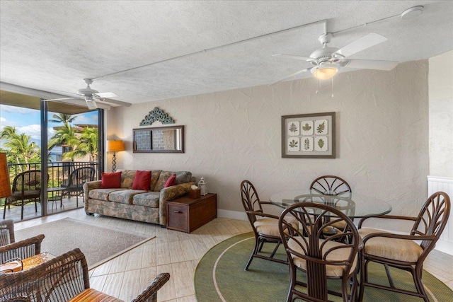 living room with ceiling fan and expansive windows