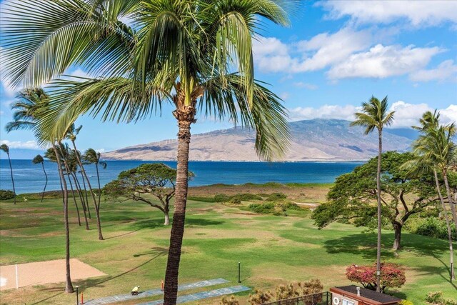 view of home's community featuring a yard and a water and mountain view