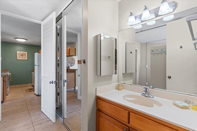 bathroom featuring tile patterned flooring and vanity