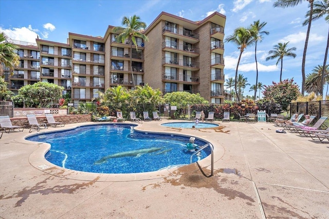 view of swimming pool with a patio and a hot tub