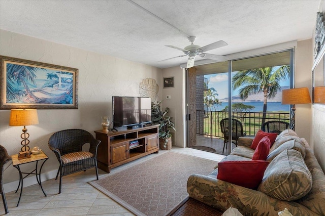 tiled living room featuring ceiling fan and a textured ceiling