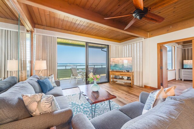 living room with ceiling fan with notable chandelier, wooden ceiling, light hardwood / wood-style flooring, and beam ceiling