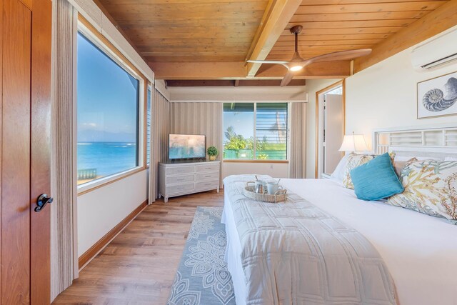 bedroom featuring a water view, beamed ceiling, wooden ceiling, and an AC wall unit