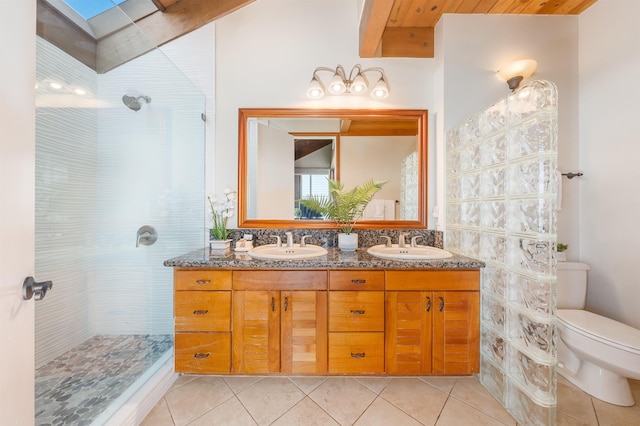 bathroom featuring toilet, tile patterned floors, a skylight, and vanity