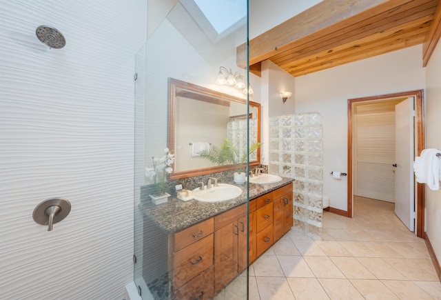 bathroom with wooden ceiling, vaulted ceiling with skylight, tile patterned floors, and vanity