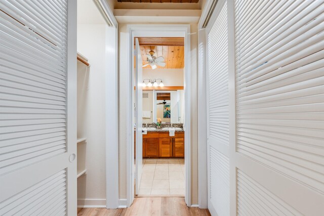 hallway featuring sink and light hardwood / wood-style flooring