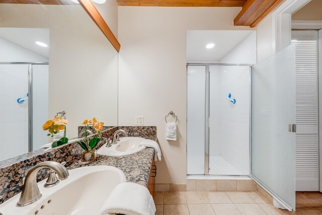 bathroom with vanity, walk in shower, and tile patterned flooring