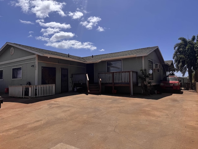 view of front of house featuring a deck and driveway