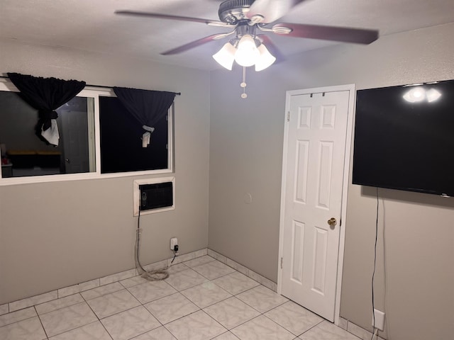 spare room with light tile patterned floors and a ceiling fan