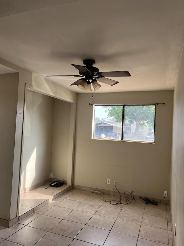 spare room with light tile patterned floors and ceiling fan