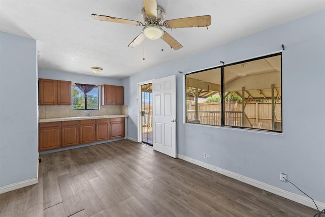 286 Humupea St, Kihei, HI 96753 - kitchen with brown cabinets, wood finished floors, ceiling fan, decorative backsplash, and tile counters