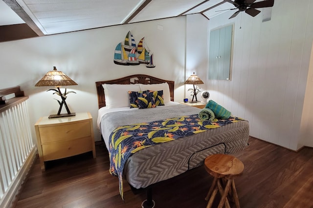 bedroom with beamed ceiling, ceiling fan, and hardwood / wood-style flooring