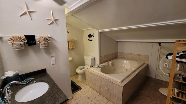 bathroom with tile flooring, tiled tub, vanity, and toilet