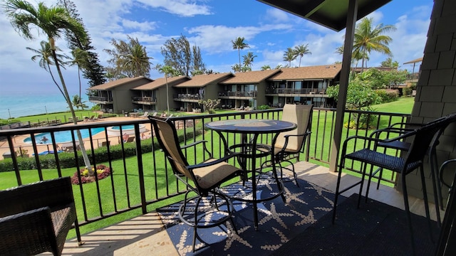 balcony with a fenced in pool