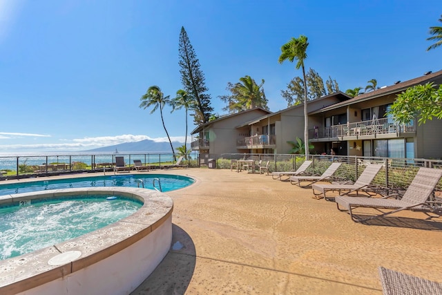 view of swimming pool with a community hot tub and a patio