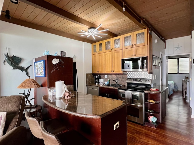 kitchen with dark hardwood / wood-style flooring, beamed ceiling, stainless steel appliances, backsplash, and ceiling fan