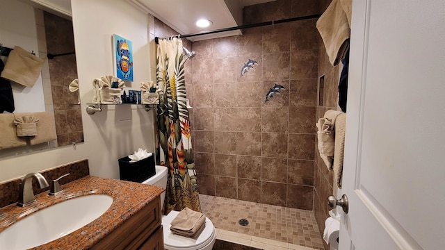 bathroom featuring curtained shower, vanity, and toilet