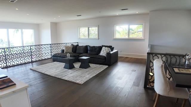 living room with recessed lighting, dark wood-style flooring, visible vents, and plenty of natural light