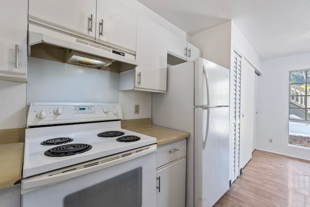 kitchen with white appliances, light hardwood / wood-style floors, and white cabinetry