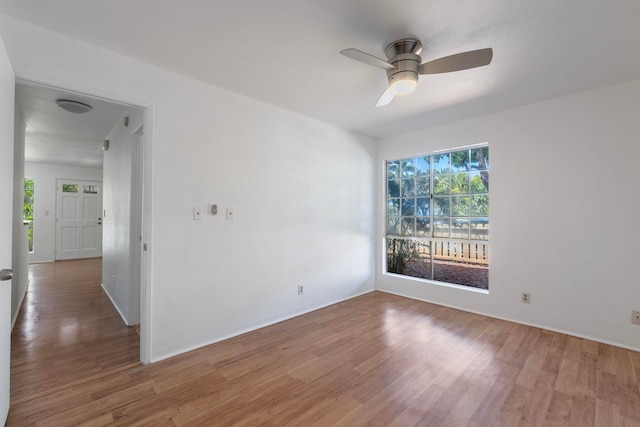 empty room with ceiling fan and hardwood / wood-style flooring