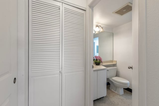 bathroom with tile patterned floors, vanity, and toilet