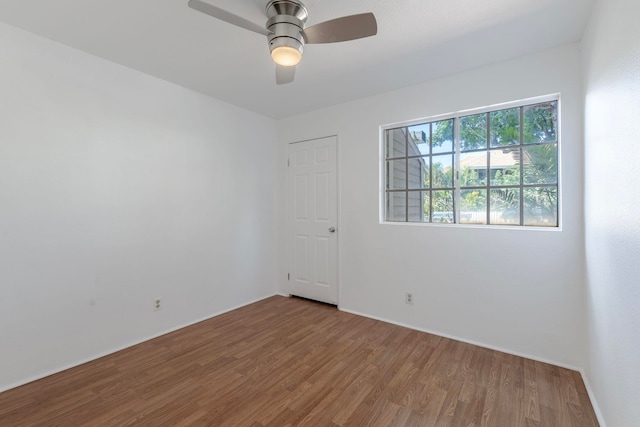 spare room with wood-type flooring and ceiling fan