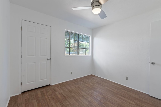 spare room with ceiling fan and dark hardwood / wood-style floors