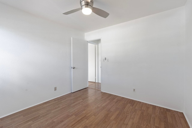 empty room with ceiling fan and wood-type flooring