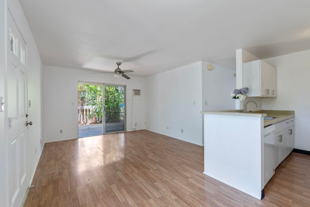 kitchen with ceiling fan, white cabinetry, sink, and light hardwood / wood-style floors