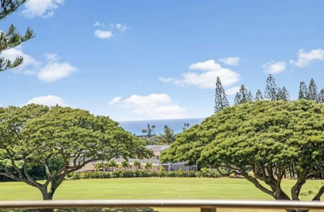 view of property's community with a water view and a yard