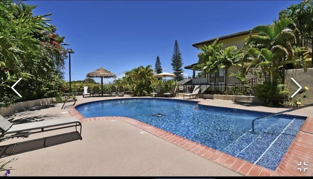 view of swimming pool featuring a patio and a gazebo