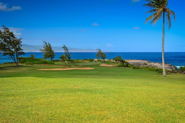 surrounding community with a yard and a water and mountain view